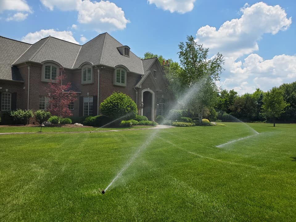 sprinkler head adjusting on green lawn